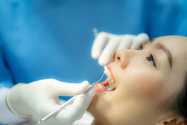 Doctor examining patient's teeth, Cosmetic dentistry